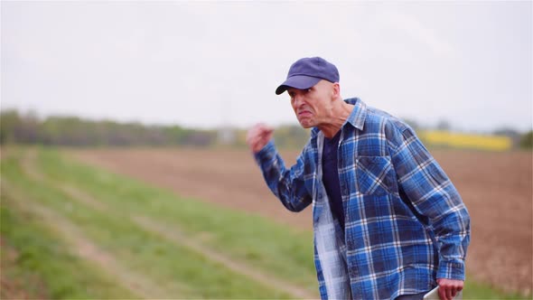 Extremely Angry Farmer In Field alt