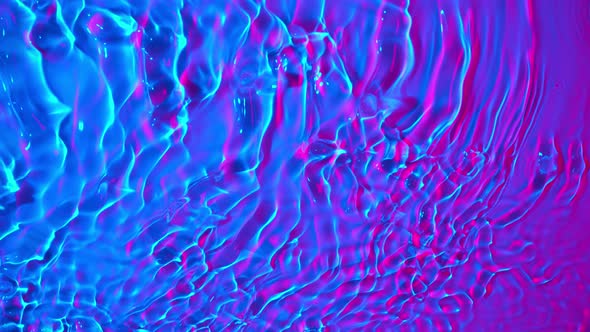 Super Slow Motion Abstract Shot of Swirling Neon Water at 1000Fps alt