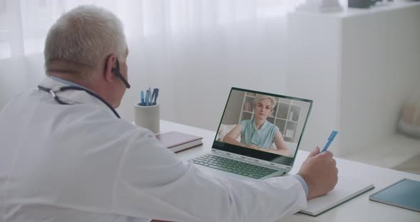 Online Appointment of Therapist, Middle-aged Woman Is Calling By Videoconference and Talking alt