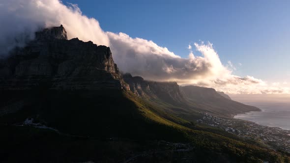 Clouds enveloping the Twelve Apostles at sunset, Cape Town; aerial alt
