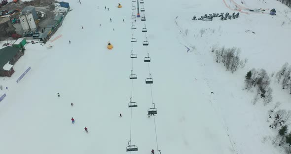 Aerial View: Ski Resort, Slope and Chair Lift. Cableway Lifts Skiers To the Mountain Hill. Winter alt