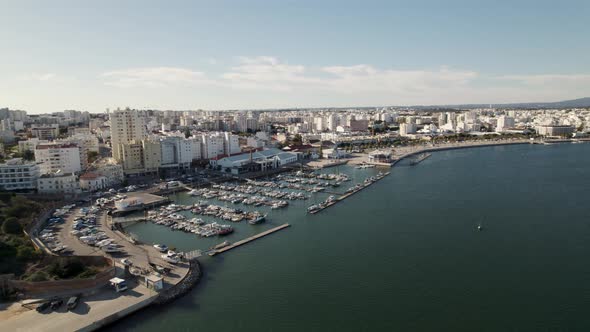Portimao port against riverside, Portimao cityscape. Algarve vacations concept alt