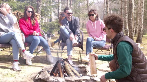 Happy Friends Sits Around Campfire, Chatting and Smiling, Enjoying Bbq Party