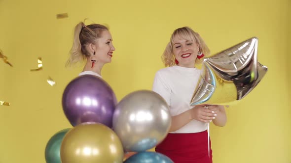 Happy Girls Having Party and Dancing on Yellow Background alt