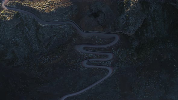 Aerial view of a car driving a serpentine road, Reunion. alt