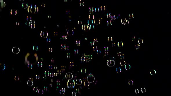 Lot Soap Bubbles Fly in the Air. Black Background alt