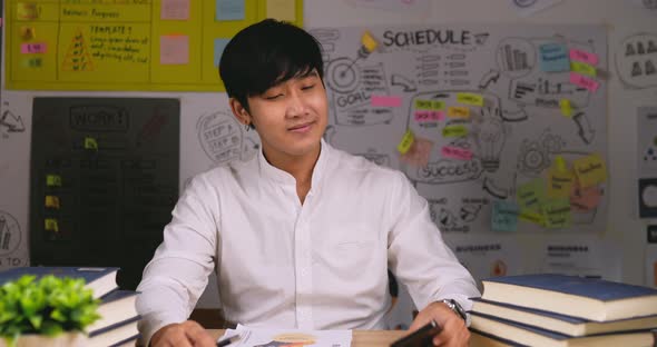 Businessman talking on mobile phone at home alt