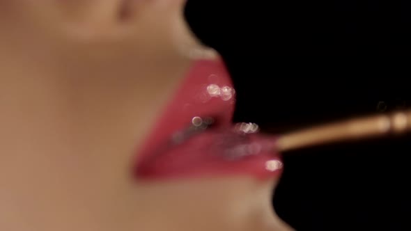 Make-up Artist Applying Liner To the Lips. Black. Closeup alt