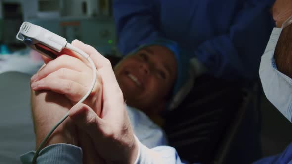 Close-up of Caucasian man comforting pregnant woman during labor in operation theater  alt
