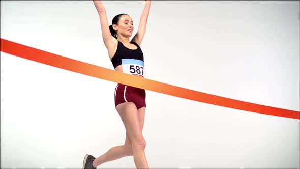 Young female running and crossing the finish line, Slow Motion alt