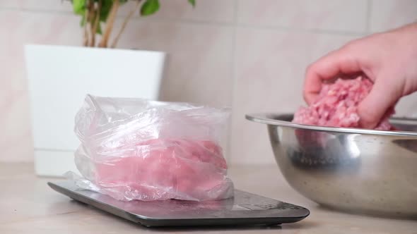 A Man Lays Out Portioned Pork and Beef Minced Meat on the Scales in Bags for Storage in Freezer