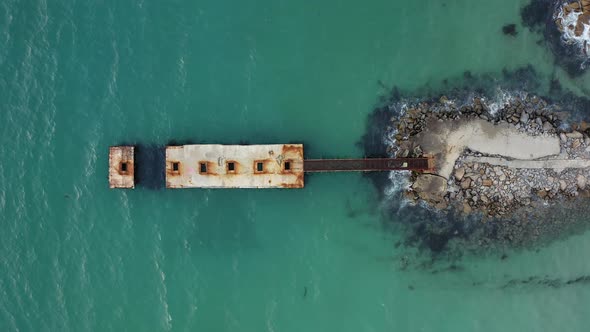 Old Pier in the Sea Surrounded By Clear Turquoise Water alt