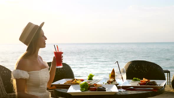 Beautiful Girl Wear Hat Enjoy Her Vacation Looking at Sea Fine Dining Food Set alt
