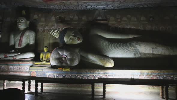 DAMBULLA, SRI LANKA - FEBRUARY 2014: Big reclining Buddha at the Golden Temple of Dambulla. The Gold alt