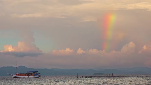 Sunset Rainbow Over a Tropical Pier