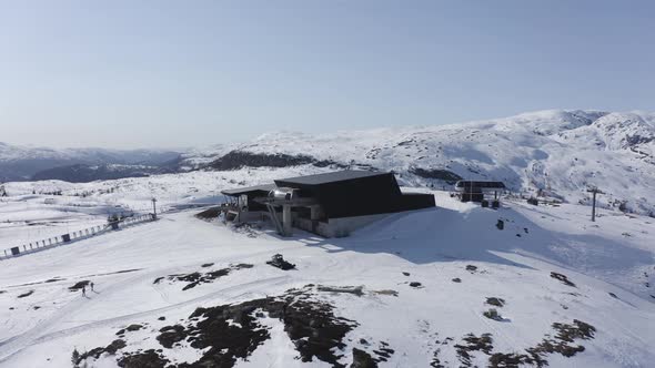 Ascending tilt down aerial Voss resort Ski destination at Mount Hangurstoppen - Clear sunny day at e alt