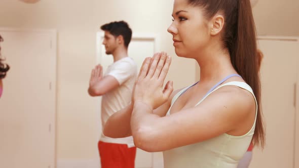 Man and woman performing yoga alt
