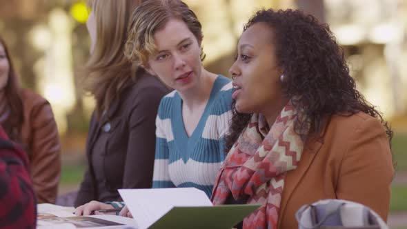 Group of college students on campus meeting outdoors