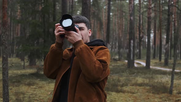 A Photographer Takes Pictures in the Woods a Young Man Takes Pictures in the Woods with His Camera alt