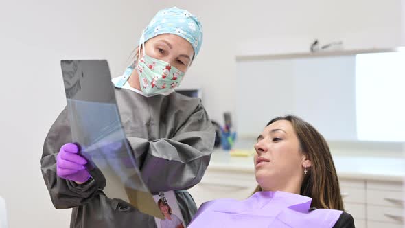 Doctor Dentist Showing Patient's Teeth on Xray alt