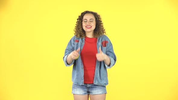 Young Cheerful Woman Showing Thumbs Up, Gesture Like, Over Yellow Background alt