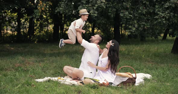 Father and Mother Playing with Son.