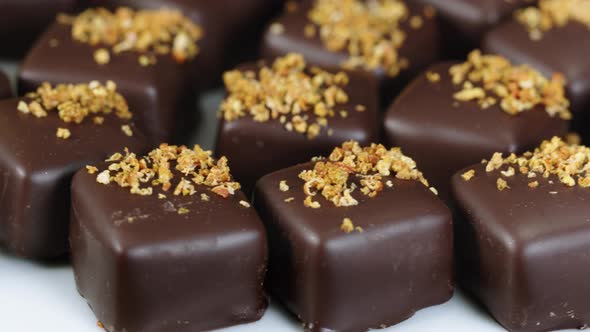 Delicious Dark Chocolate Candies with Dry Fruit Crumbs Decoration Rotating