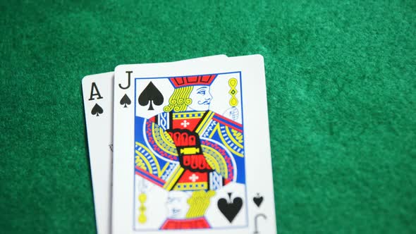 Two playing cards on poker table in casino 4k alt