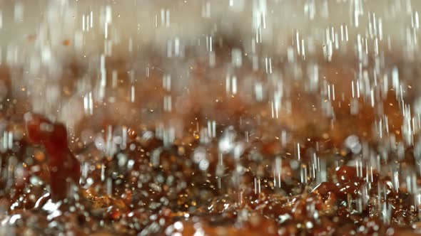 Super Slow Motion Macro Shot of Splashing Fresh Coffee and Water Droplets at 1000 Fps. alt