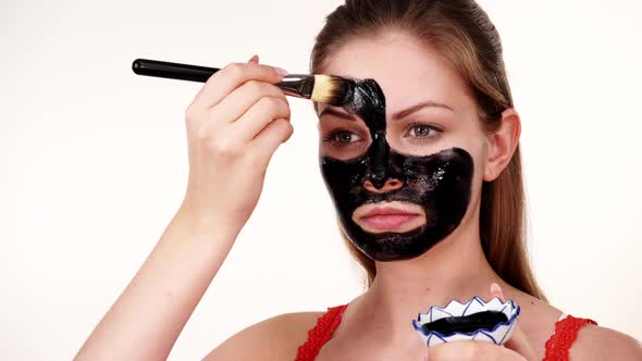 Girl Apply Black Carbo Mask to Face