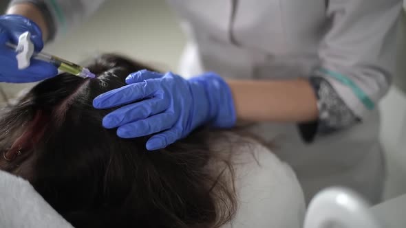 The Doctor Puts Injections Into the Scalp