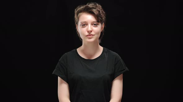 Portrait of Confident Smiling Young Brunette Woman Looking at Camera Showing Strength Gesture alt