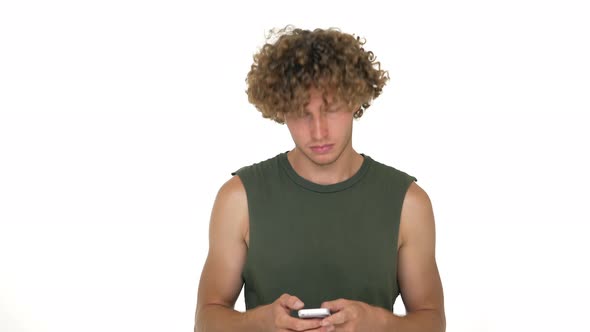 Young Handsome Man Checking Out Cellphone Rolling His Eyes Expressing He's Tired and Bored with a alt