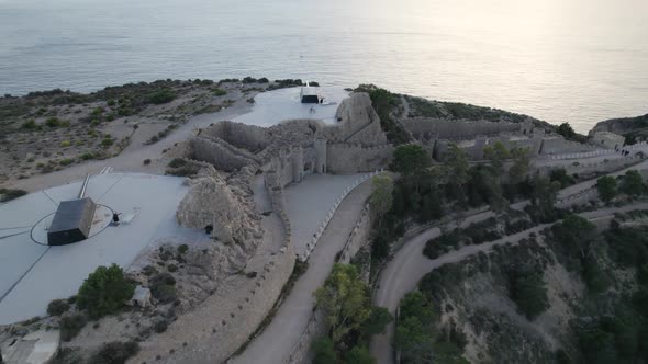 Castillitos battery at golden hour overlooking Mediterranean Sea; aerial