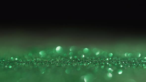 Abstract Background of Green Sparkles in Out of Focus alt