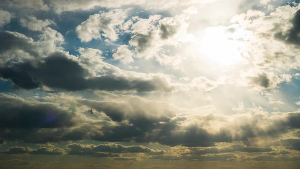 White Fluffy Clouds Slowly Float Through the Blue Daytime Sky Timelapse alt
