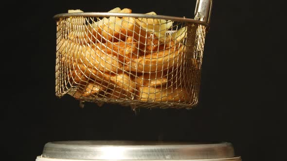 A potato fries take out from a fryer
