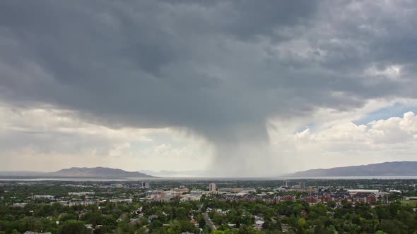 Rain storm moving over Provo city durning the hot summer alt