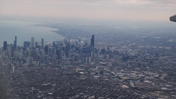 The Plane Flies Over the City of Chicago USA Lands at the Airport alt