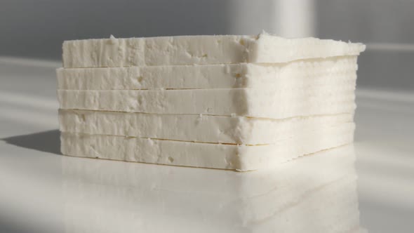 Close-up of stacked cow milk cheese pieces 4K footage alt