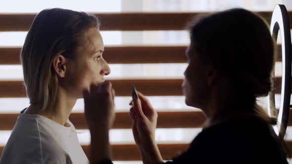 Pretty Actress Waits for Stylist to Apply Makeup