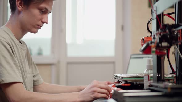 Man Using 3d Printer at Workplace