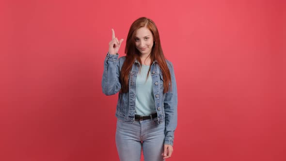 Young Woman Showing And Raising A Finger As A Sign Of The Best Idea 