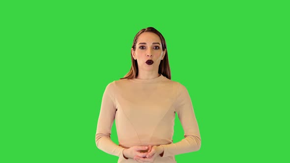 Cyber Girl Walks Telling Something Fast on a Green Screen Chroma Key