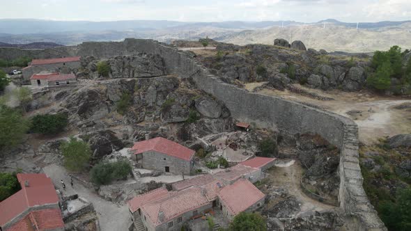 Ruins of defensive wall of Sortelha Fortress surrounding this historic village