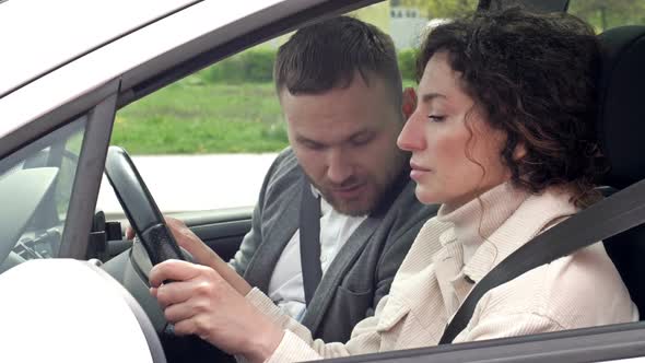 Male Instructor and Female Student Driving Lesson