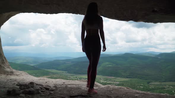 Girl Traveler Walks Through Cavern. Cave City in Vicinity of Bakhchisarai - Tope Kermen in Crimea alt