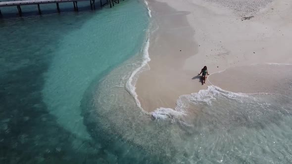 Aerial View of a Beach with a Woman Sunbathing Lying on a Sand with Island View in Background