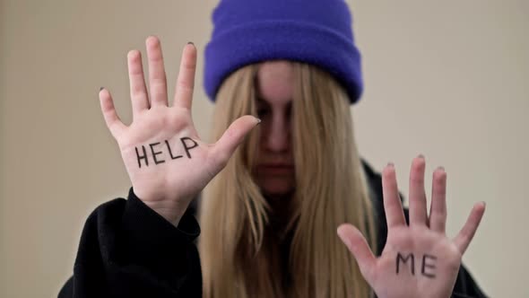 Portrait of a Frustrated Teenage Girl Showing Her Palms with the Inscription HELP ME alt