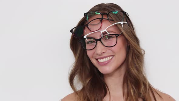 Brunette Wearing Four Different Pairs of Glasses